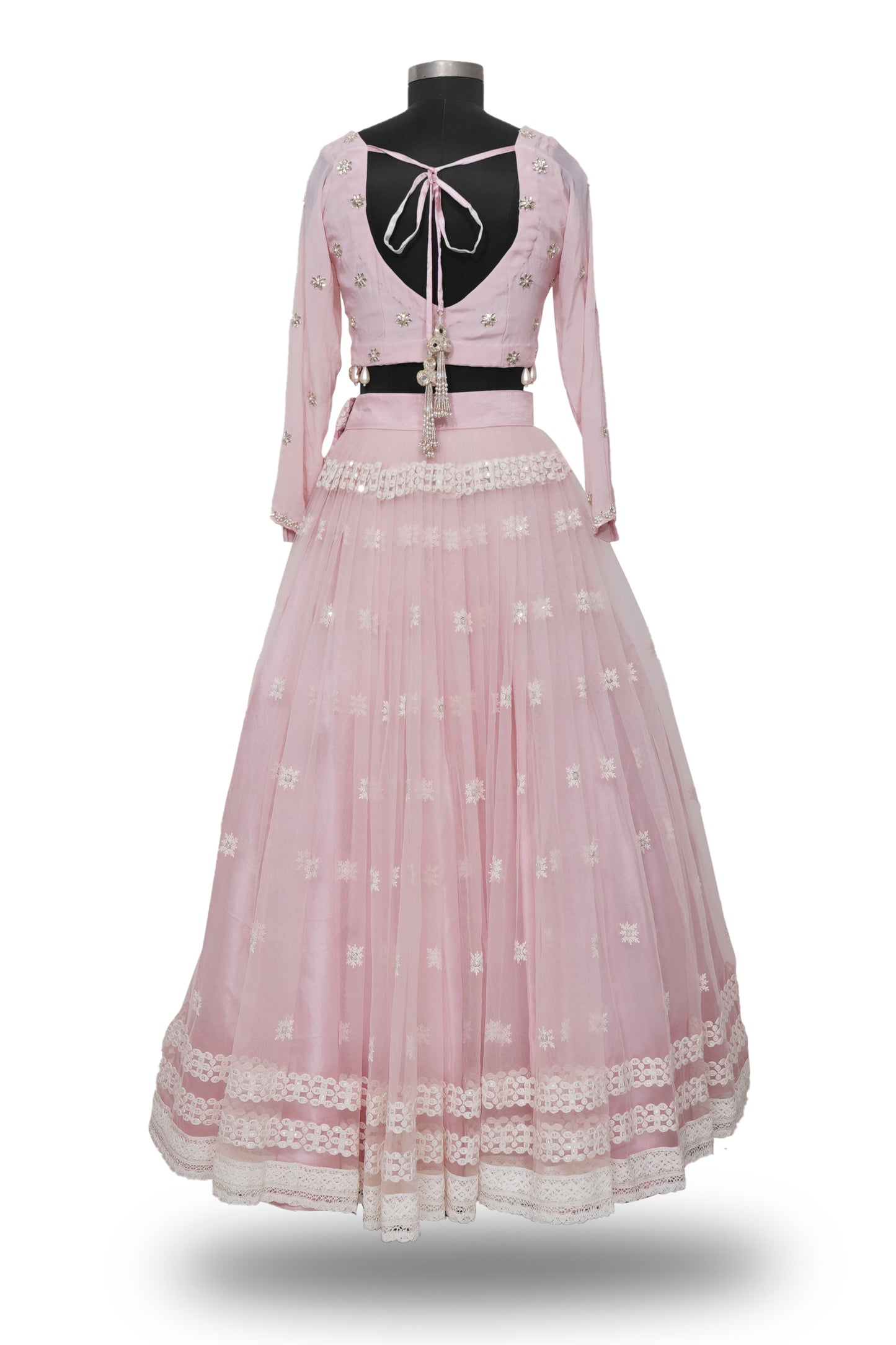 "Radiant in Pink: A Tulle Lehenga with Hand-Embroidered Blouse Adorned with Embellished Hangings"