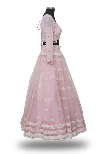 "Radiant in Pink: A Tulle Lehenga with Hand-Embroidered Blouse Adorned with Embellished Hangings"