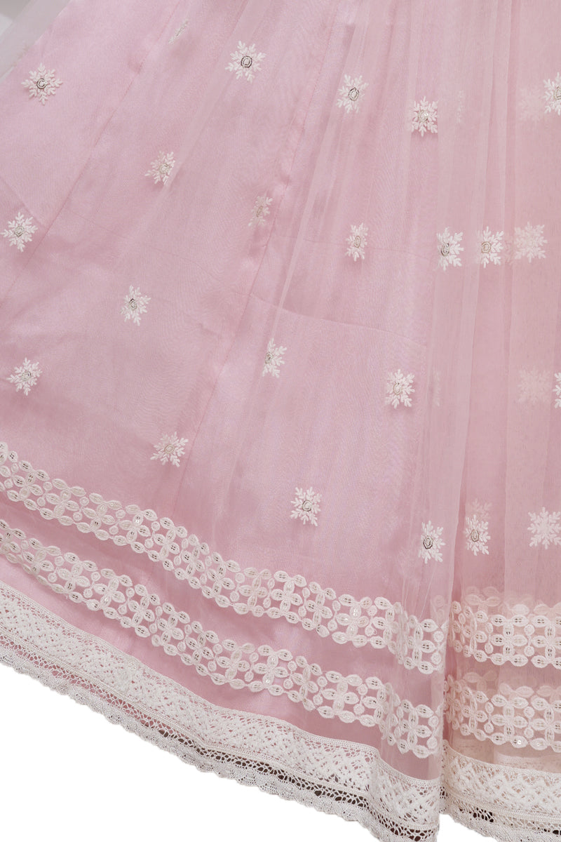 "Radiant in Pink: A Tulle Lehenga with Hand-Embroidered Blouse Adorned with Embellished Hangings"